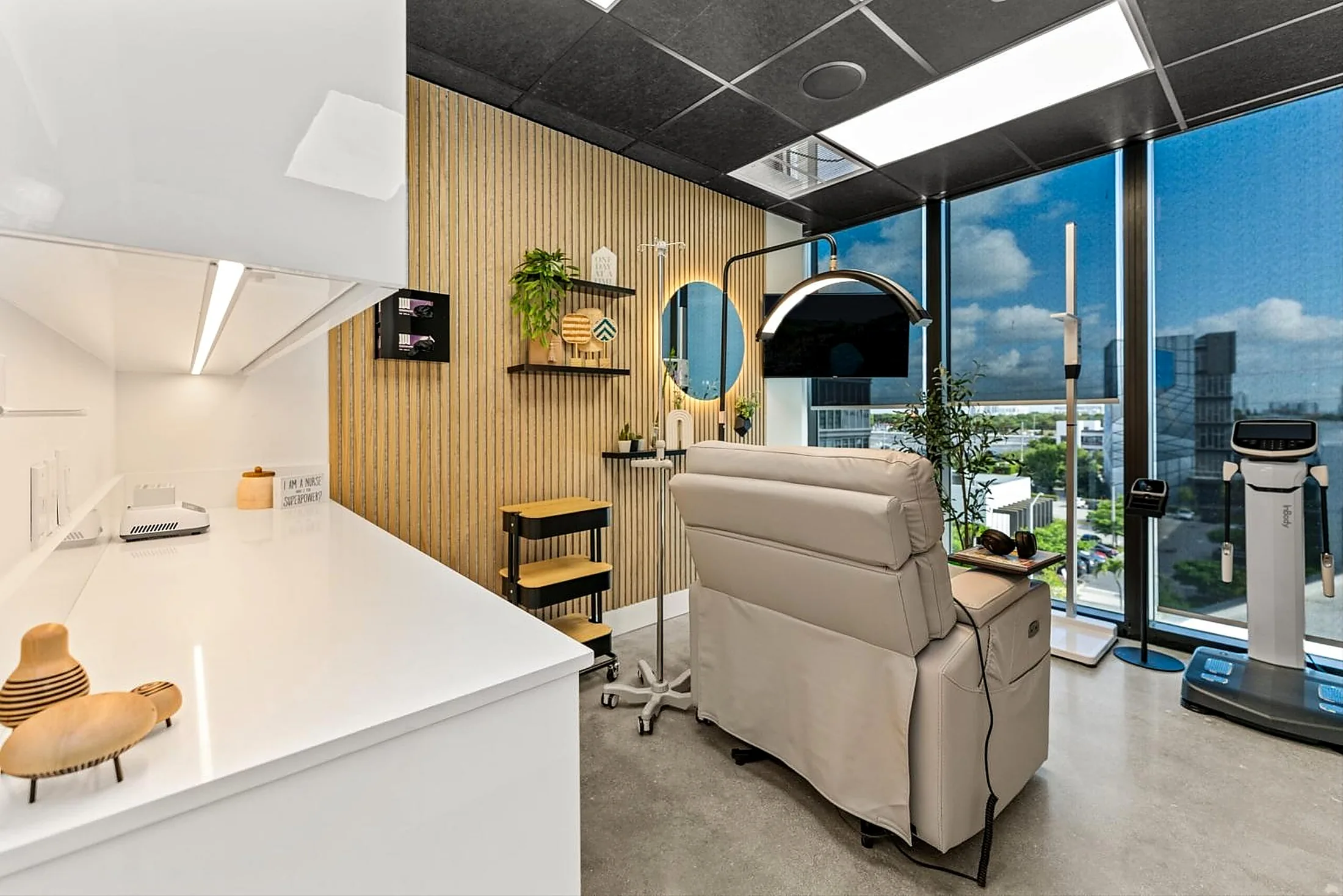 Treatment room with wood slat feature wall and drywall soffit